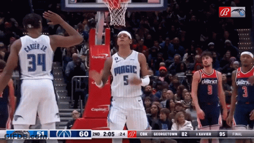 A Basketball Player With The Number 5 On His Jersey Stands In Front Of A Crowd GIF