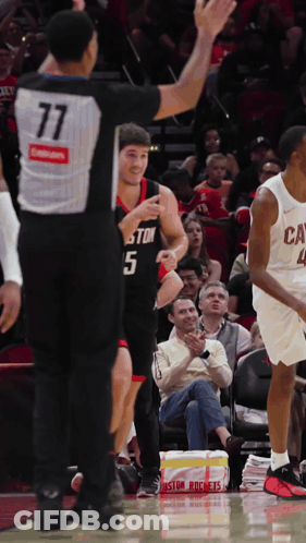 A Basketball Player With The Number 5 On His Jersey Talks To The Referee GIF