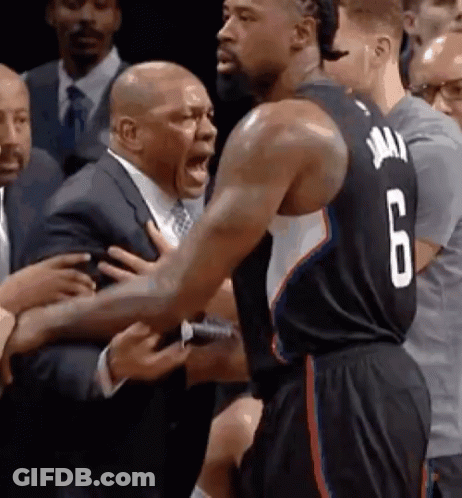 A Basketball Player With The Number 6 On His Jersey Is Being Held By A Man In A Suit GIF