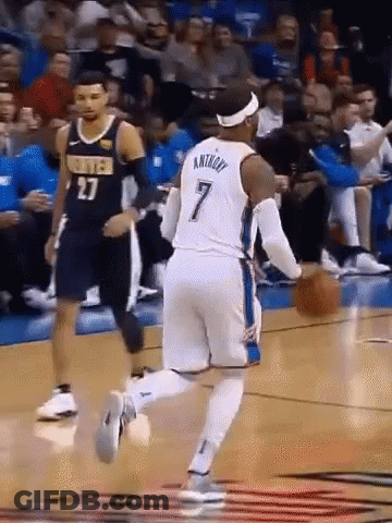 A Basketball Player With The Number 7 On His Jersey Dribbles The Ball GIF
