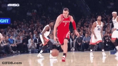 A Basketball Player With The Number 7 On His Jersey Is Dribbling A Basketball GIF