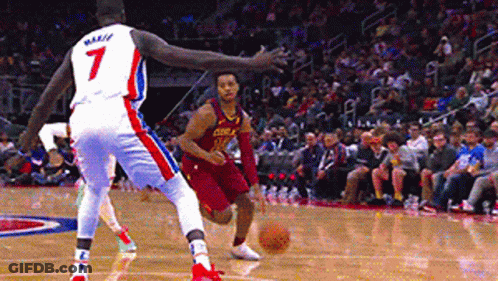 A Basketball Player With The Number 7 On His Jersey Is Dribbling A Basketball GIF