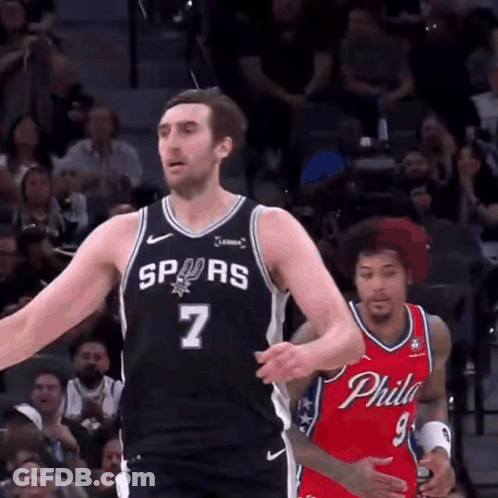 A Basketball Player With The Number 7 On His Jersey Stands In Front Of A Philadelphia Player GIF