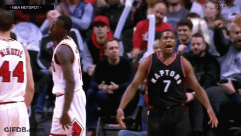 A Basketball Player With The Number 7 On His Jersey Stands In Front Of Another Player GIF