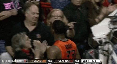 A Basketball Player With The Number 77 On His Jersey Stands In Front Of A Crowd GIF