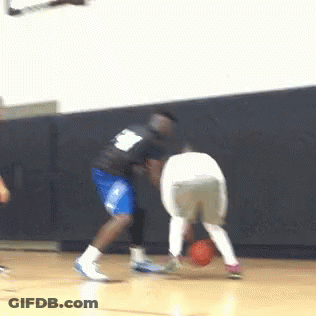 A Basketball Player With The Number 8 On His Back Dribbles The Ball GIF