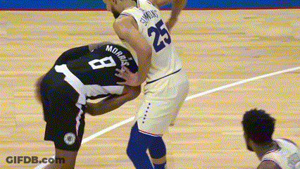 A Basketball Player With The Number 8 On His Back Is Being Tackled By Another Player GIF