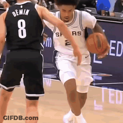 A Basketball Player With The Number 8 On His Jersey Dribbles The Ball GIF