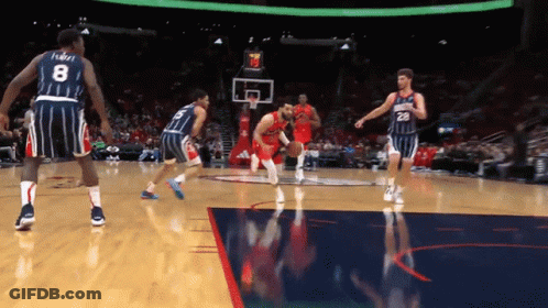 A Basketball Player With The Number 8 On His Jersey Dribbles The Ball GIF