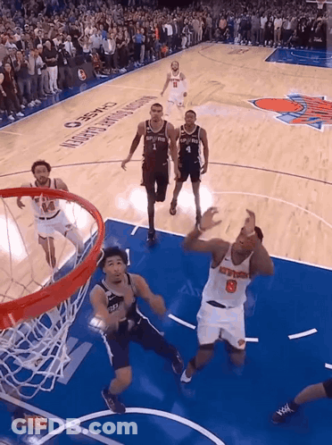 A Basketball Player With The Number 8 On His Jersey Goes For A Dunk GIF