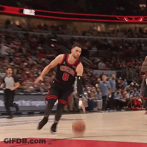 A Basketball Player With The Number 8 On His Jersey Is Dribbling The Ball GIF