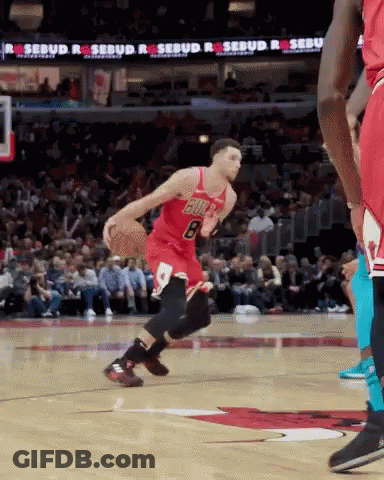 A Basketball Player With The Number 8 On His Jersey Is Dribbling The Ball GIF