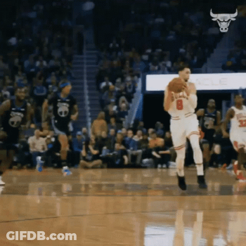 A Basketball Player With The Number 8 On His Jersey Is Holding A Basketball GIF