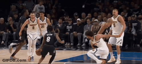 A Basketball Player With The Number 8 On His Jersey Is Surrounded By Other Players GIF