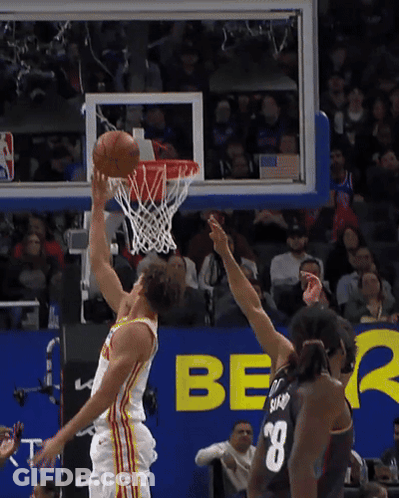 A Basketball Player With The Number 8 On The Back Of His Jersey Shoots The Ball GIF