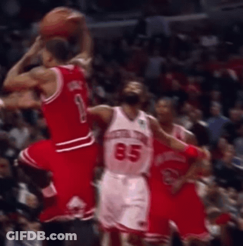 A Basketball Player With The Number 85 On His Jersey Is Jumping To Catch The Ball . GIF