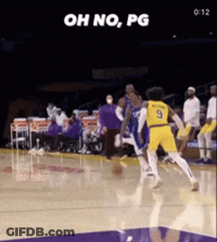 A Basketball Player With The Number 9 On His Jersey Is Trying To Block Another Player GIF