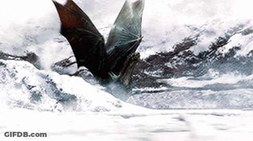 A Bat Is Flying Over A Snow Covered Landscape GIF