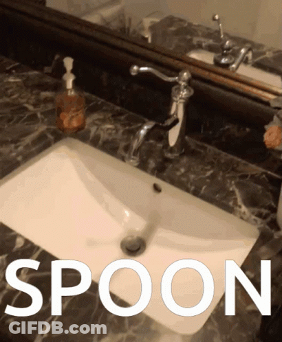 A Bathroom Sink With The Word Spoon Written Above It GIF