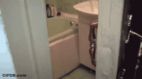 A Bathroom With A Sink And Bathtub And A Door Open GIF