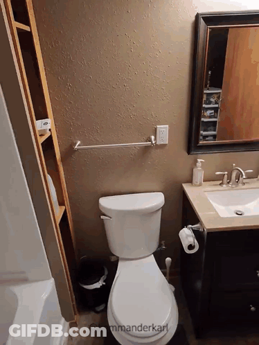A Bathroom With A Toilet A Sink And A Mirror With The Words " Kommanderkarl " On The Bottom GIF