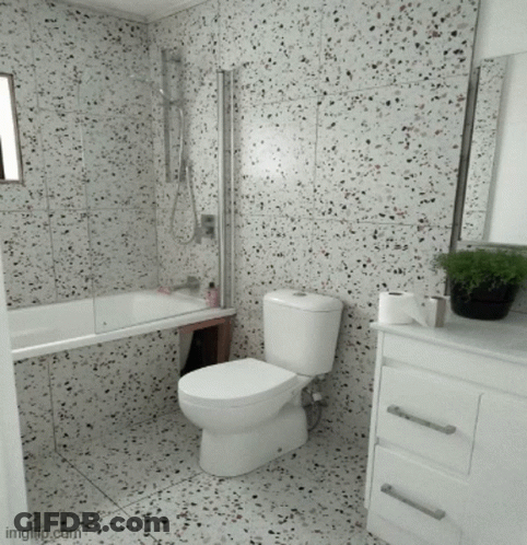 A Bathroom With A Toilet A Sink And A Tub GIF