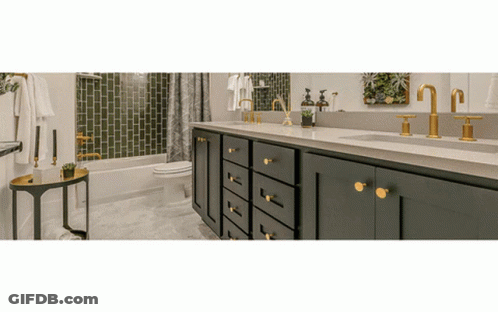A Bathroom With Two Sinks A Toilet And A Bathtub GIF