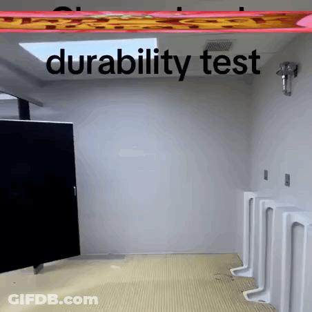 A Bathroom With Urinals And The Words " Durability Test " Above It GIF
