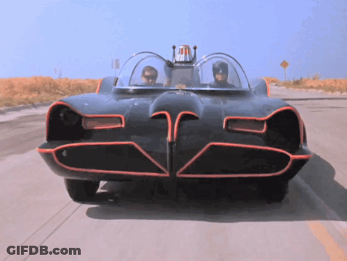 A Batman Car Is Driving Down The Road GIF