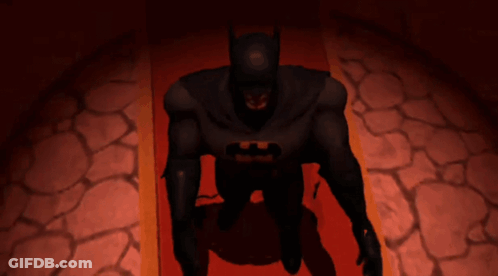 A Batman Laying On A Red Carpet With His Hands Outstretched GIF