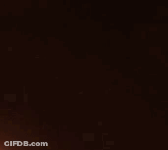 A Beam Of Light Is Shining Through A Dark Background GIF