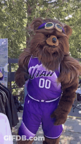 A Bear Mascot Wearing A Utah Jersey And Shorts GIF
