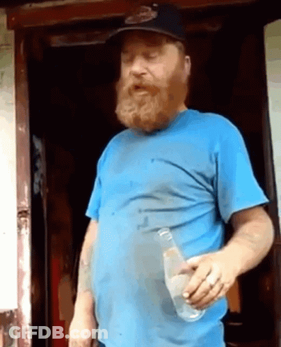 A Bearded Man In A Blue Shirt Holds A Bottle Of Water GIF