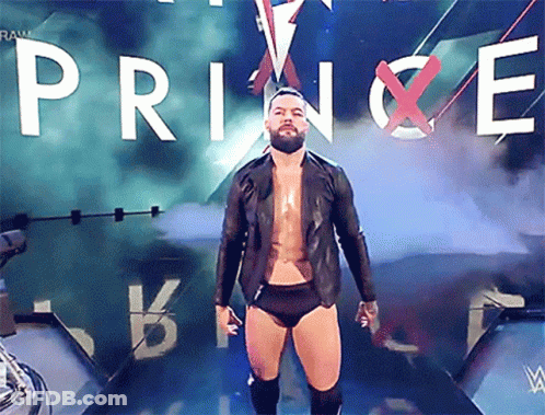 A Bearded Wrestler Stands In Front Of A Banner That Says Prince GIF