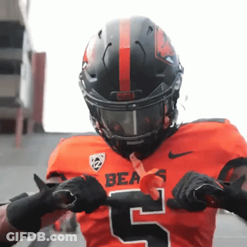 A Bears Football Player Wearing A Black Helmet And Gloves GIF