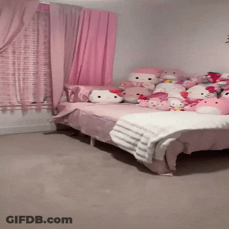 A Bed In A Room With Hello Kitty Stuffed Animals GIF