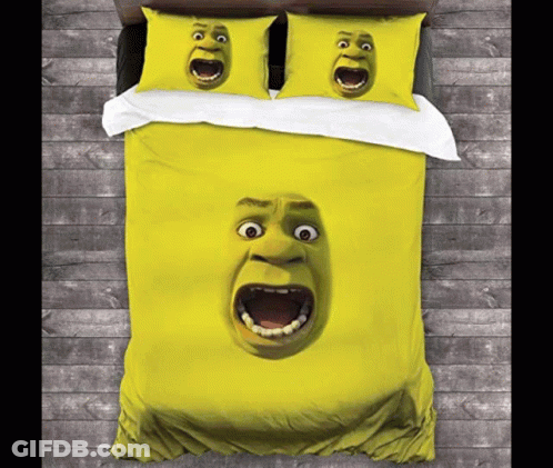 A Bed With A Duvet Cover And Pillows With Shrek 'S Face On Them GIF