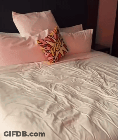 A Bed With A Pillow That Says Pop GIF