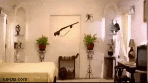 A Bedroom With A Bed And A Rifle On The Wall GIF