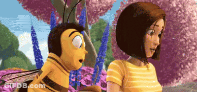 A Bee And A Woman Are Standing Next To Each Other In A Field Of Flowers . GIF
