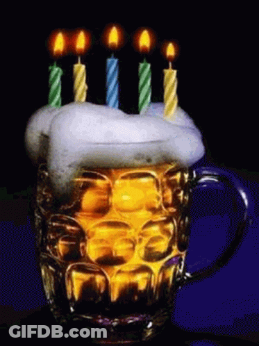 A Beer Mug With Candles On Top Of It And Foam On Top . GIF