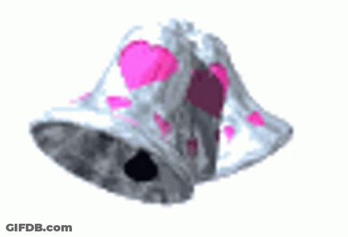 A Bell With Pink Hearts On It Is Floating In The Air . GIF