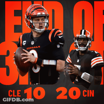 A Bengals Football Player Holding A Ball Next To Another Player GIF