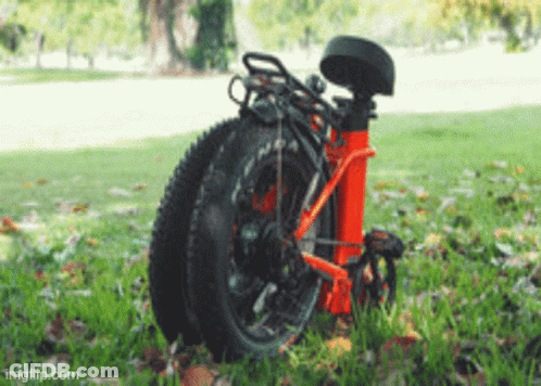 A Bicycle Is Folded Up And Sitting In The Grass With Imgflip.com Written On The Bottom GIF