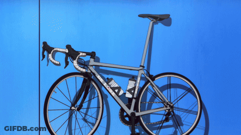 A Bicycle With A Purple Background And A Purple Glow GIF