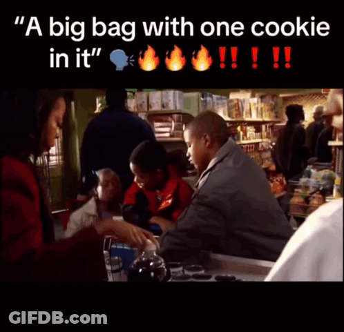 A Big Bag With One Cookie In It Is Being Held By A Man GIF