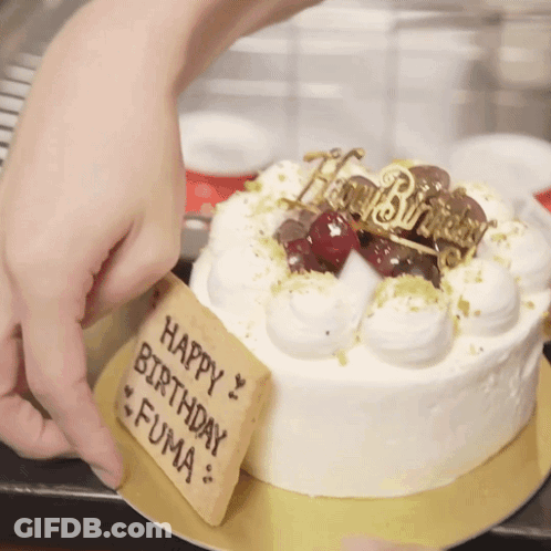 A Birthday Cake With A Sign That Says Happy Birthday Fuma On It GIF