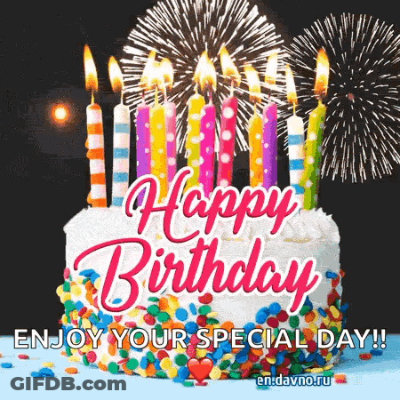 A Birthday Cake With Candles And Fireworks In The Background GIF