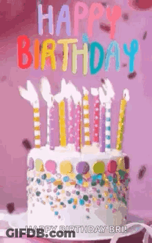 A Birthday Cake With Candles And Sprinkles On It And The Words `` Happy Birthday '' Written On It . GIF