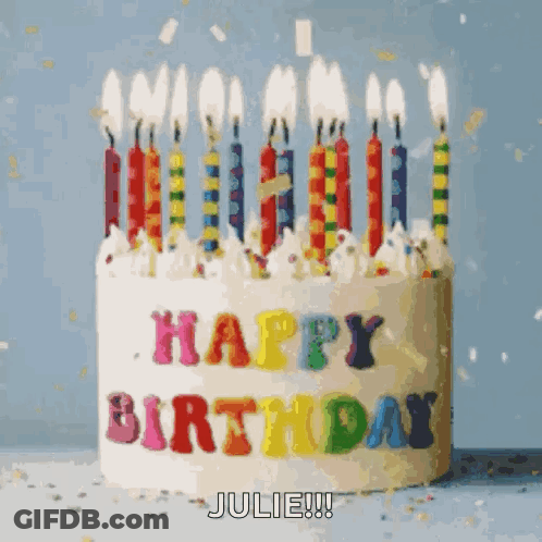 A Birthday Cake With Candles And The Words Happy Birthday Julie On It GIF